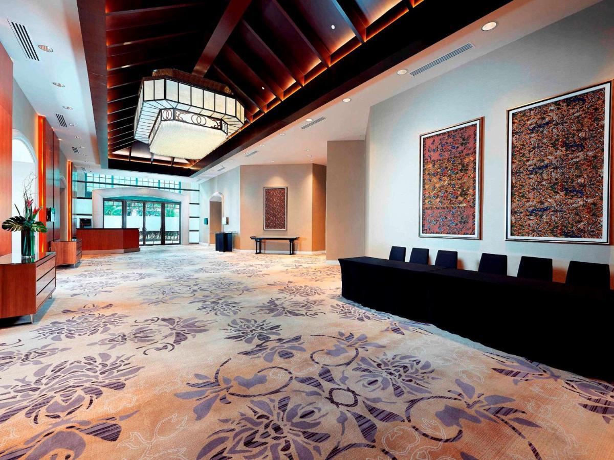Paradox Singapore Merchant Court At Clarke Quay Exterior photo The photo depicts a spacious and elegantly designed lobby area. The ceiling features a distinctive wooden design with soft lighting. On the walls, there are large decorative art pieces that add to the aesthetic appeal. The floor is covered with a pat