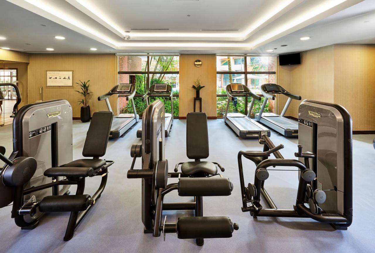 Paradox Singapore Merchant Court At Clarke Quay Exterior photo The photo shows a gym or fitness center with various exercise equipment. There are several treadmills positioned against large windows that let in natural light, and some strength training machines are arranged in the space. The gym has a modern desi