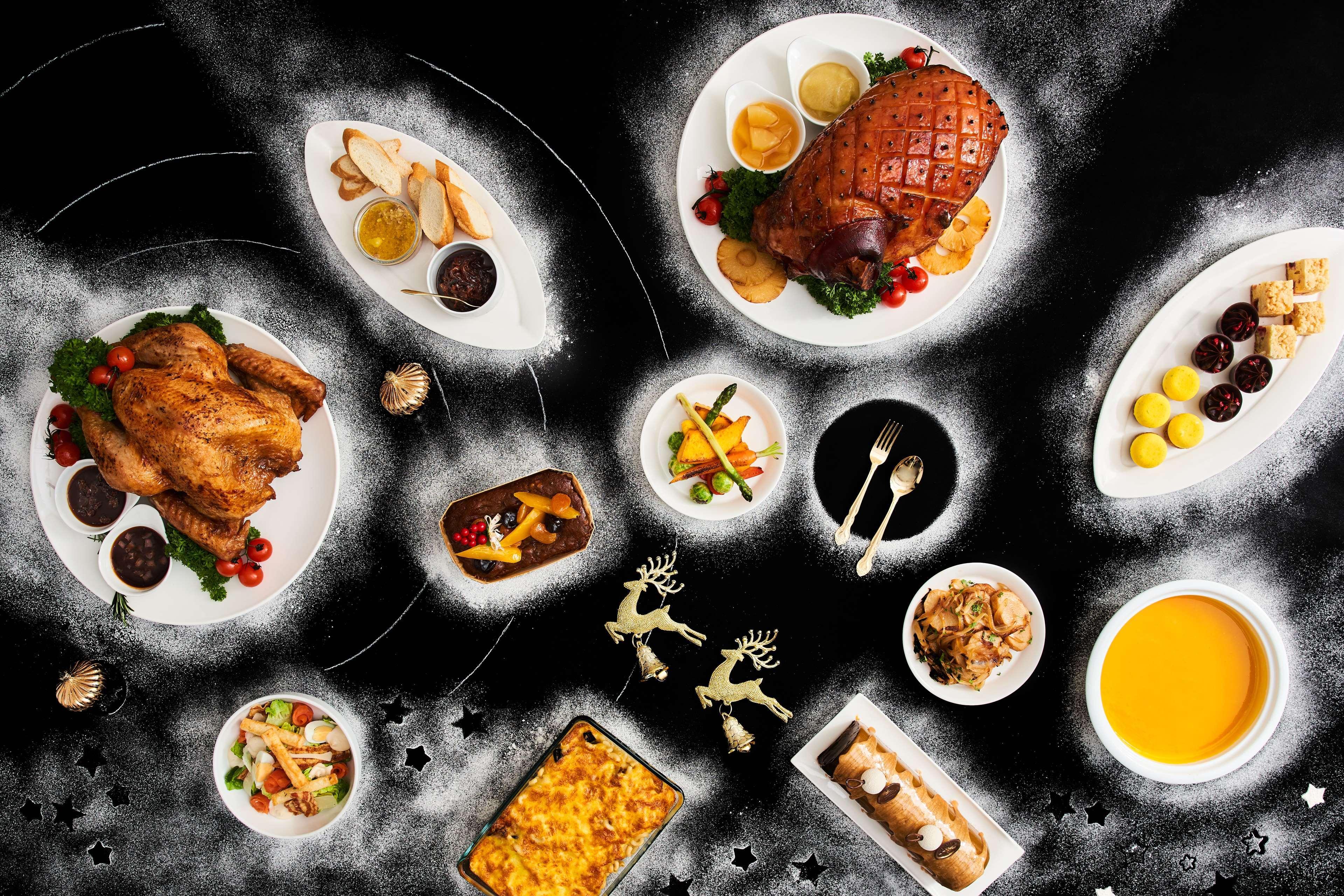 Paradox Singapore Merchant Court At Clarke Quay Exterior photo The photo depicts a variety of dishes arranged artistically on a dark backdrop. In the center, there is a large roasted ham, garnished with herbs. Surrounding it are several plates featuring a whole roasted chicken, a colorful vegetable medley, and a