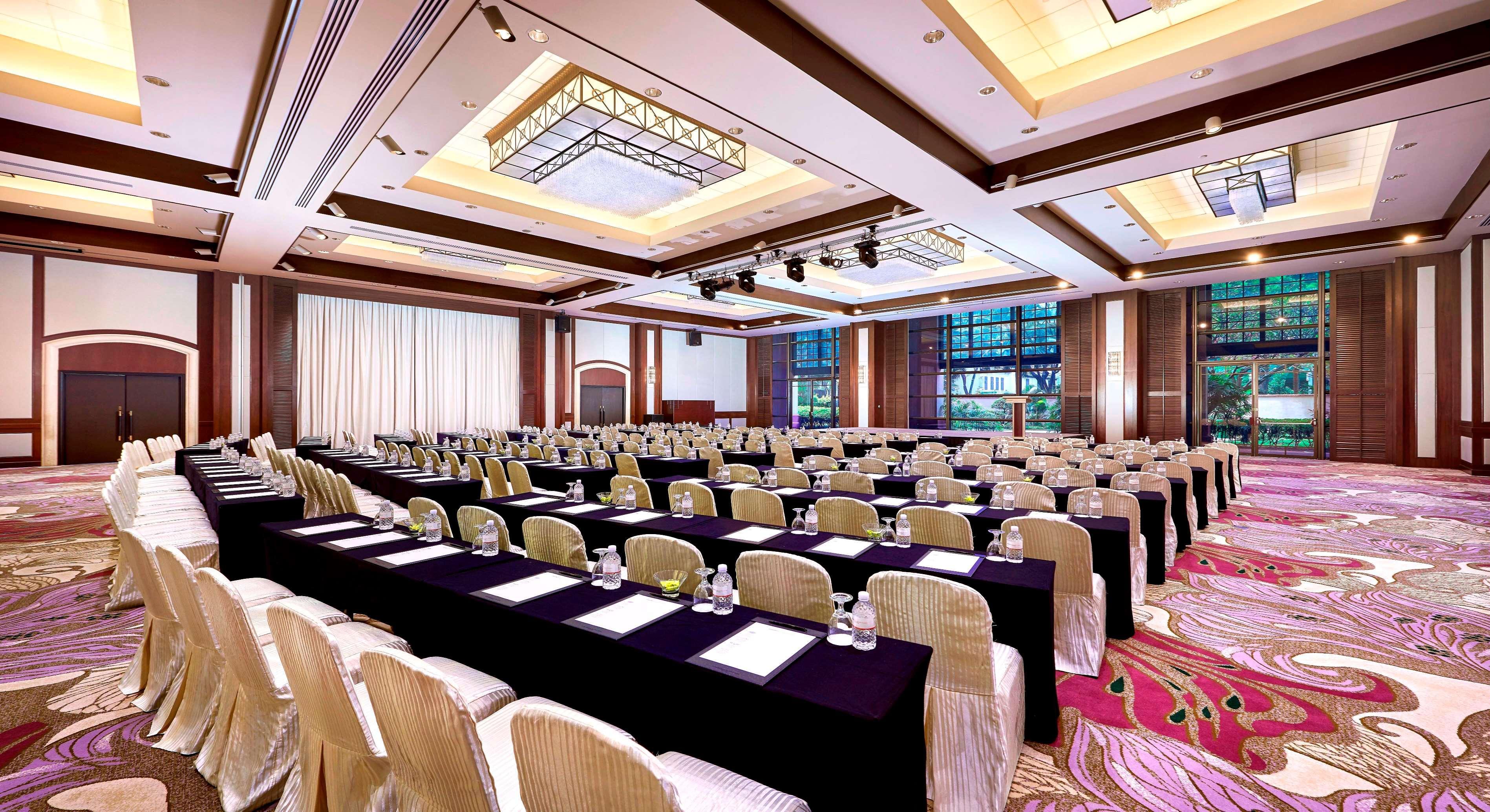 Paradox Singapore Merchant Court At Clarke Quay Exterior photo The photo shows a large conference room set up for an event or meeting. The room features multiple rows of tables covered with black cloths and arranged with chairs. Each table has water glasses and what appears to be notepads or documents. The space